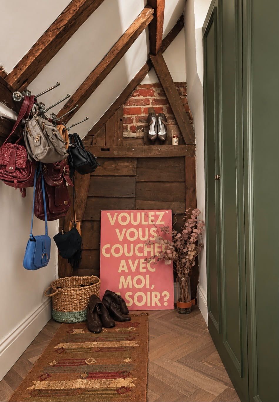 The separated dressing area off the main bedroom, coats hung beneath the roof timbers