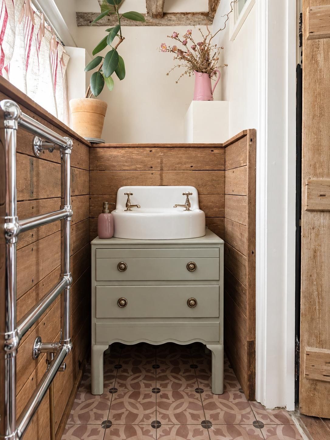 A small basin on a painted stand against timber-boarded walls