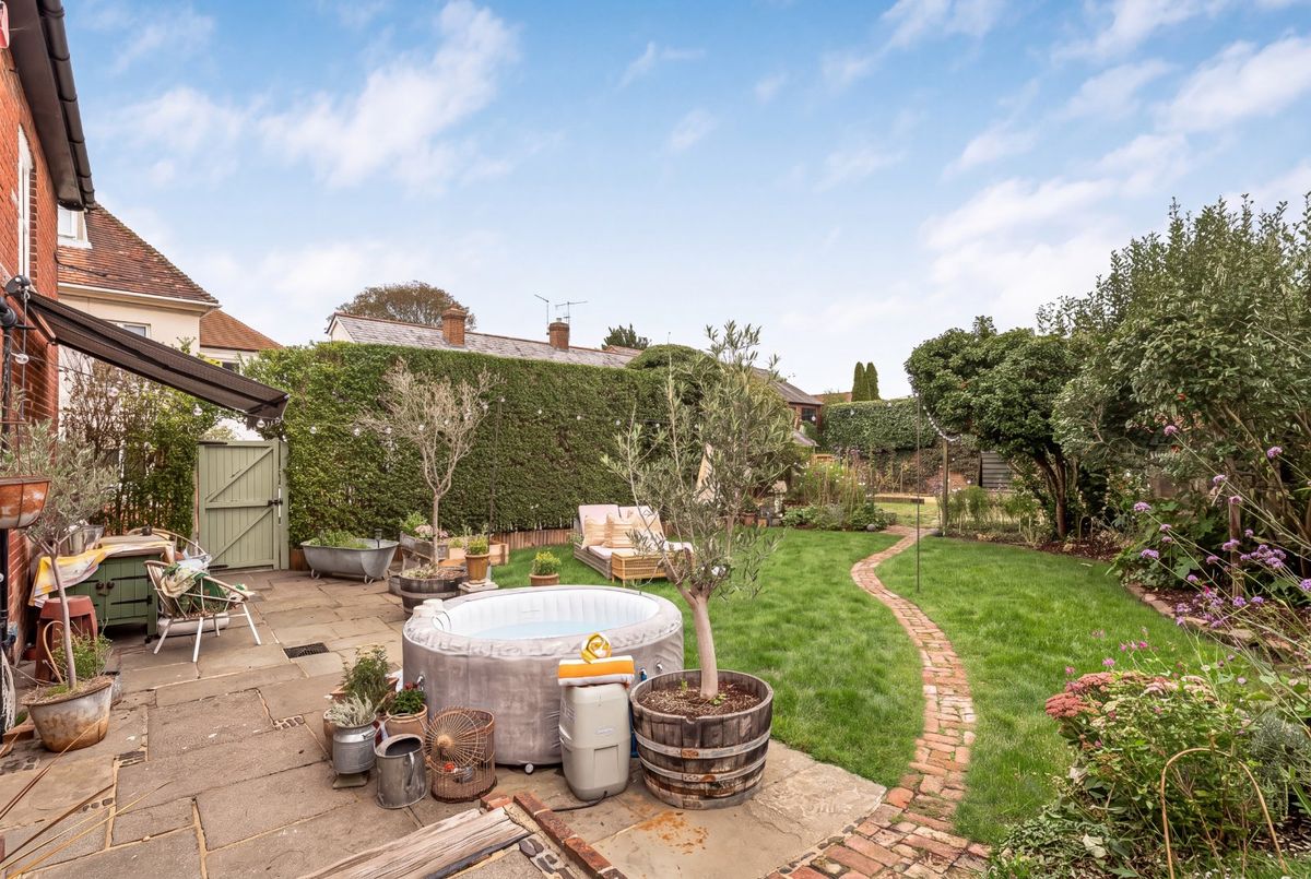 The broad paved terrace beside the house, looking out over the garden